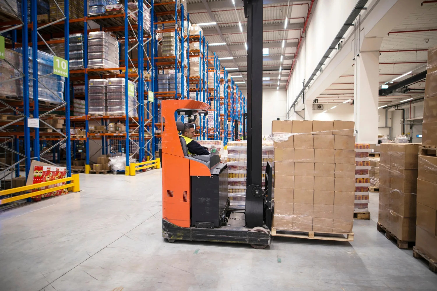 industrial-worker-protective-uniform-operating-forklift-big-warehouse-distribution-center